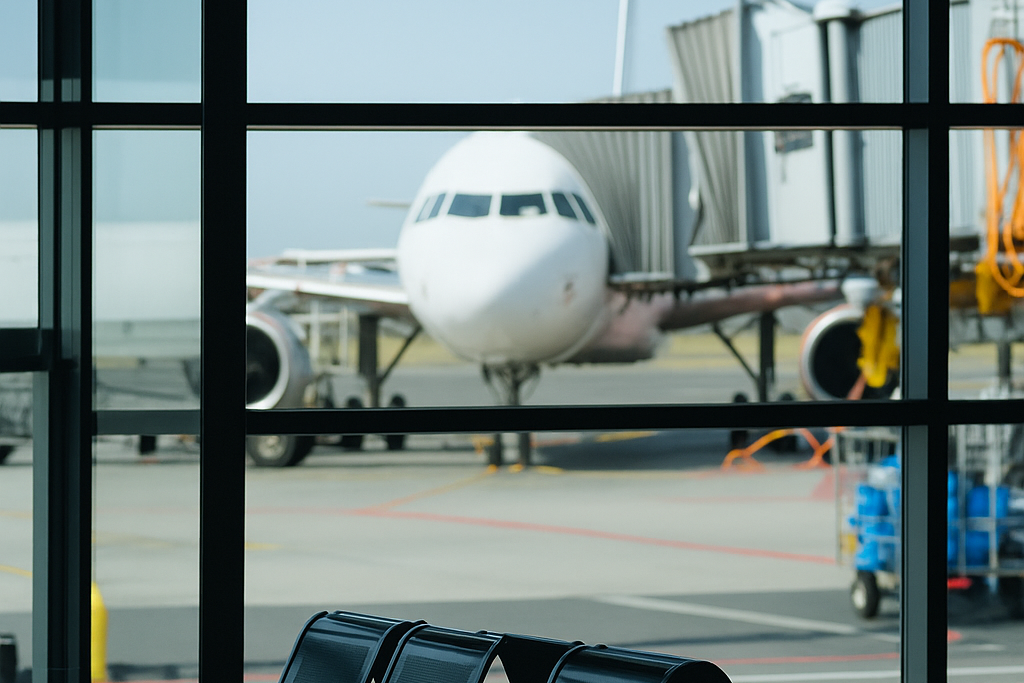 Airport terminal with seating area and airplane outside