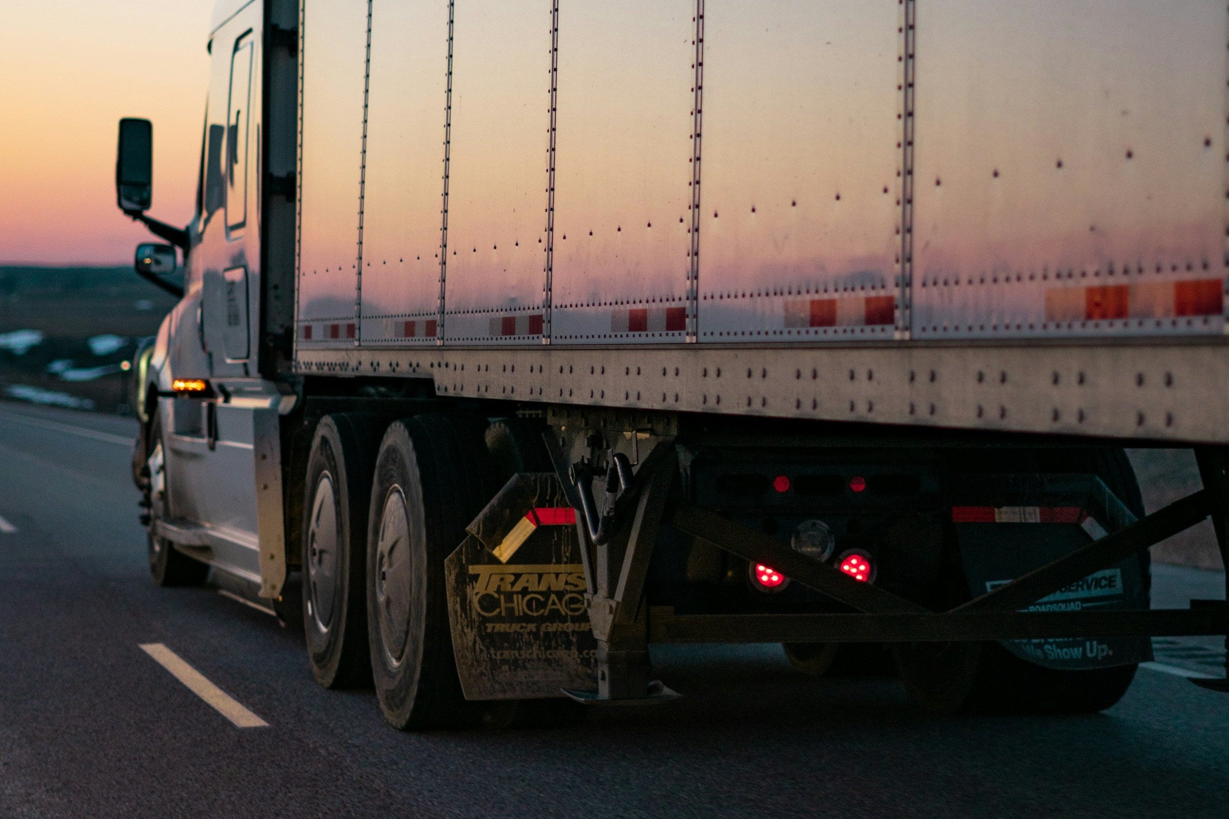 Truck on a road with a sunset or sunrise sky